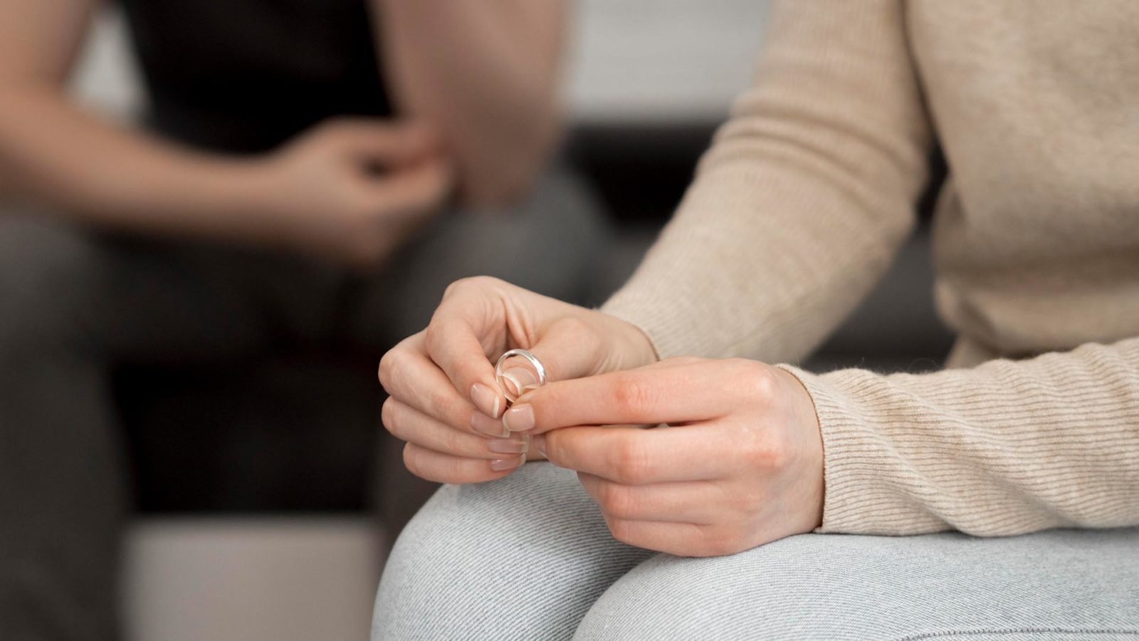 person holding a wedding ring in their hands