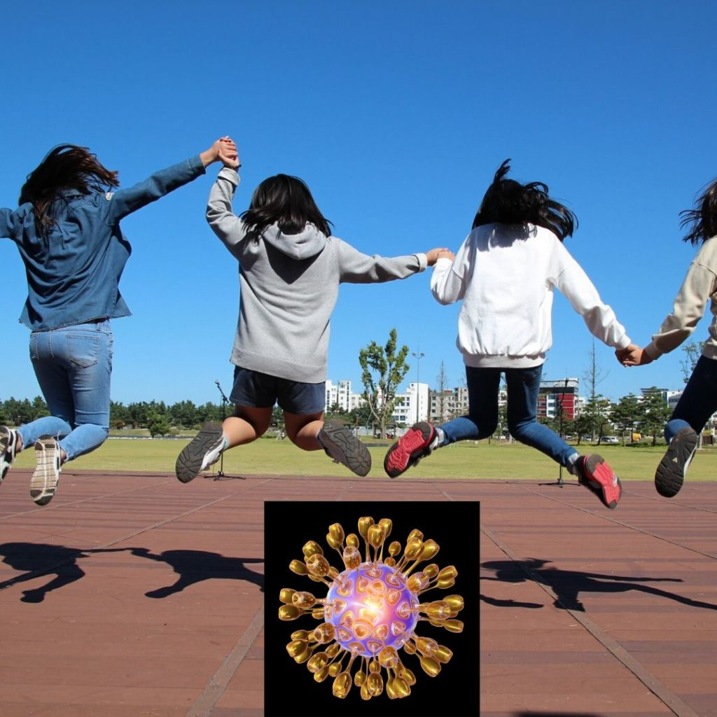 Four children holding hands and jumping outdoors under a clear blue sky, with a digital virus illustration overlay.