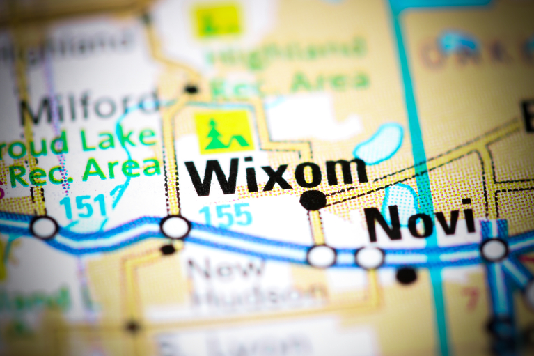 Close-up of a map highlighting Wixom, Novi, and nearby recreational areas with roads and water bodies.